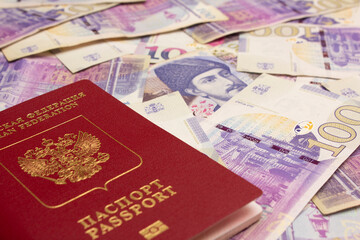 100 GEL. Close up photo of biometric Russian passport and paper cash Georgian banknote. One hundred lari. Money to pay for purchases. Cash money for travel, trip, ticket, debt, sale, tax. Banking