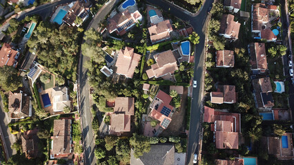 aerial view of a residential area in Spain with holiday homes and villas with pools and gardens,...