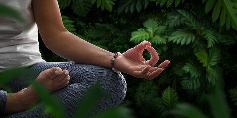 Woman in meditation position in nature