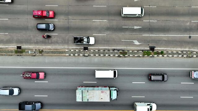 Capturing the pulse of urban transportation, an aerial tableau of a highway. Vehicles dart along marked lanes, orchestrated by the flow of traffic. A visual ode to the dynamics of city movement.
