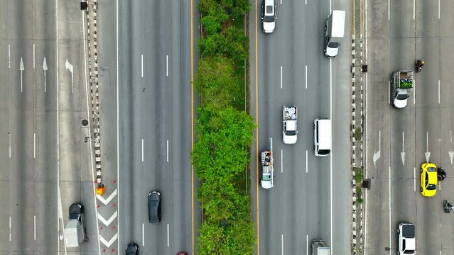 Surveying from above, witness the orchestrated chaos of the roadway - cars darting like minnows, a titan truck imposing its presence, all guided by the precision of lane delineations.
