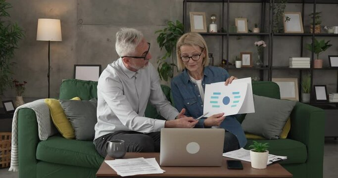 Mature man and woman work form home have consultation via video call