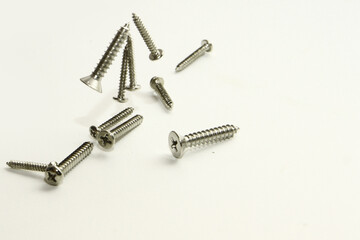 Stainless steel flat head sharp end screw on white background