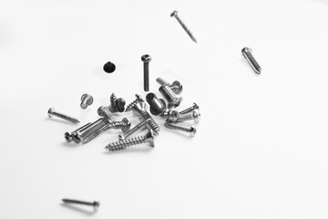 Stainless steel flat head sharp end screw on white background