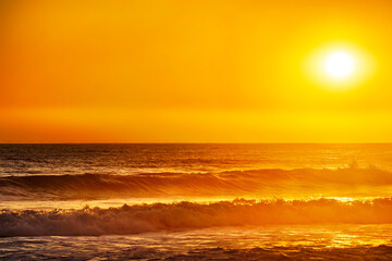 Yellow sunlight on the ocean with the sun and ocean