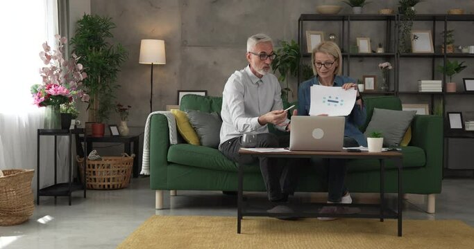 Mature man and woman work form home have consultation via video call