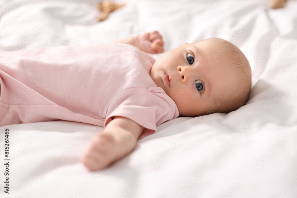 Canvas Prints Cute little baby lying on white sheets