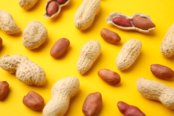 Fresh peanuts on yellow table, above view