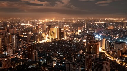 Obraz premium Aerial view of a bustling city skyline illuminated beautifully at night, capturing the urban tapestry of lights and architecture