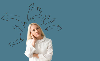 Thoughtful mature woman on blue background
