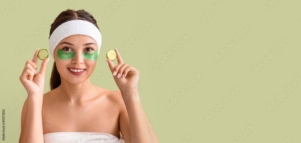 Poster pretty young woman with under-eye patches and cucumber slices on green background with space for tex