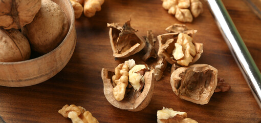 Tasty walnuts on wooden board, closeup