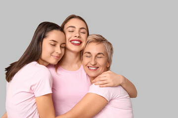 Portrait of hugging women on grey background. Women history month