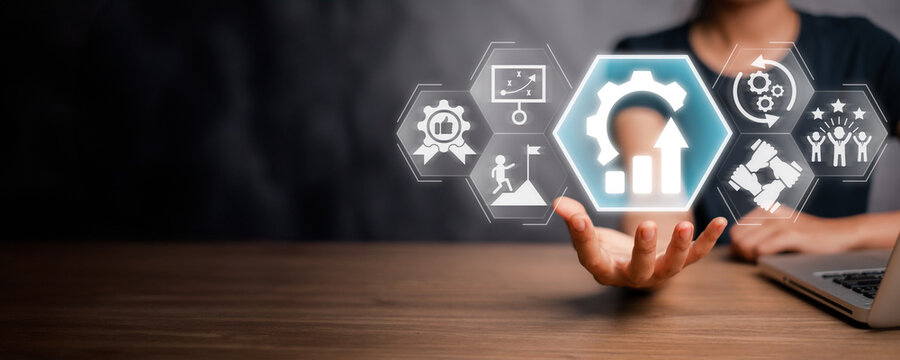 Kaizen concept, Businesswoman hand holding improvement, quality, advancement, continuous, success and implementation icon on virtual screen.