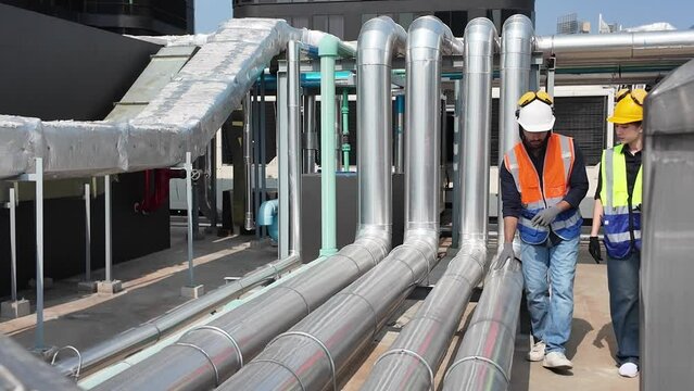 foreman female male lady girl man woman person people talk speak discussion check up metal pipeline construction factory iron equipment technology engineering material stack manufacturing plumbing 