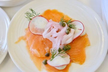 An entree of smoked salmon with herbed cream cheese, red radish, capers, pickled onion on a business class flight from Sydney to Kuala Lumpur