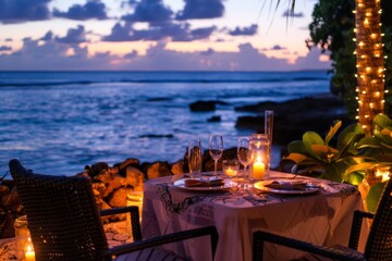 A romantic dinner for two set on a candlelit patio overlooking the ocean