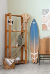 Interior of light room with shelving unit, surfboard and picture