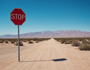 stop sign on sand road