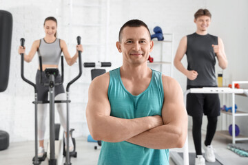 Portrait of male trainer in gym