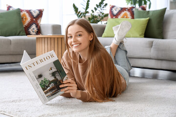 Young woman reading magazine on carpet at home