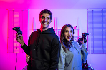 Portrait of e-sport couple gamer playing online video game on computer.