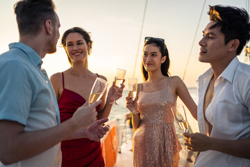 Group of diverse friends drink champagne while having a party in yacht. 