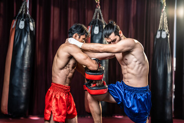 Two young professional boxer having a competition tournament on stage. 