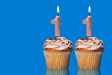 Birthday Cupcakes With Candles Lit Forming The Number 11.