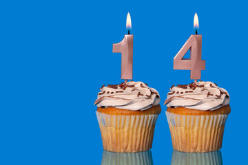 Birthday Cupcakes With Candles Lit Forming The Number 14.