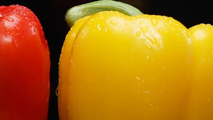 Red and yellow bell peppers in this stunning macrography against a black background. Each close-up...