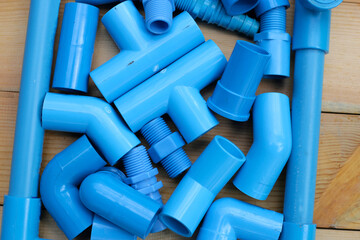 Plumber equipment with blue pvc pipe connections for plumbing work.