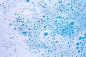Detergent foam bubble on water. Blue background, Soap sud