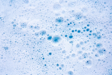 Detergent foam bubble on water. Blue background, Soap sud