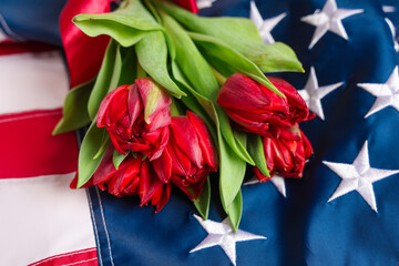 Naklejka premium Beautiful tulip flowers and flag of USA. Memorial Day celebration