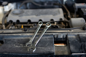 Car care maintenance and servicing, Close-up hand technician auto mechanic using the wrench to repairing change spare part car engine problem and car insurance service support.