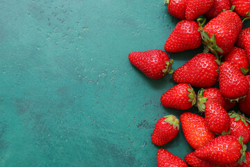 Sweet fresh strawberries on green background