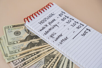 Naklejka premium Counting expenses bills on housing electricity, gas, water. Banknotes of dollar cash around. High prices for energy inflation crisis. Cut back on spending. Savings rate
