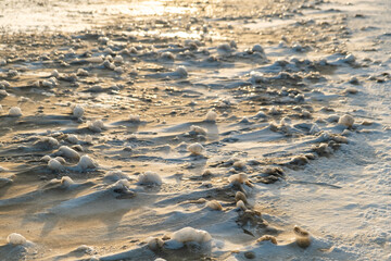 Ice dunes formed during winter in the lakeshore with Lake Michigan in background