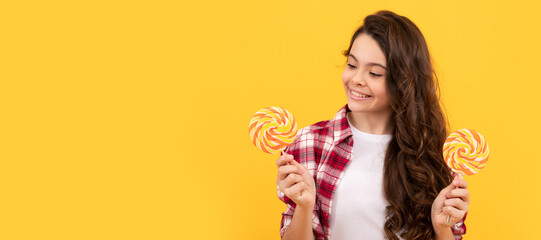 hipster kid with long curly hair hold lollypop. sugar candy on stick. caramel candy shop. Teenager child with sweets, poster banner header, copy space.