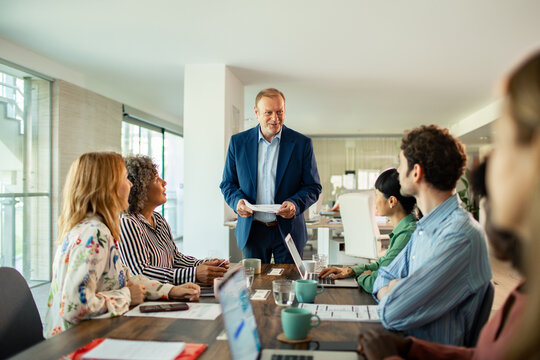 Business meeting in modern office with team of diverse employees discussing project