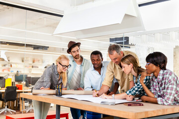 Diverse team of architects collaborating on a project in a modern office setting