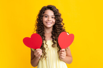 Happy teenager portrait. Happiness kids and love concept. Romantic lovely teen girl with red heart, world heart day, happy valentines day. Smiling girl.