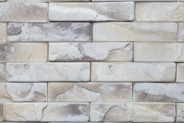 A brick wall with a white and brown color