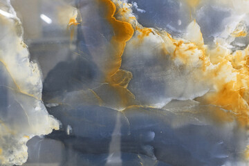 A blue and orange stone with a cloudy sky in the background