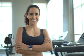 Hispanic young woman exercise in the indoor gym.