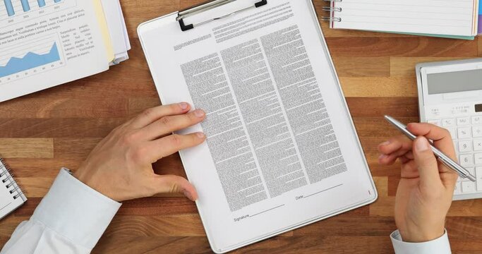 Professional review and analysis of financial documents and signature top view