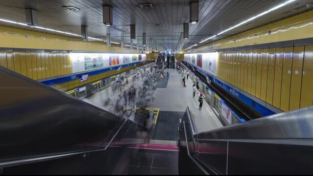 top down timelapse view of crowded passenger get on and get off from subway train while train arrive and depart from platform subway in rush hour.