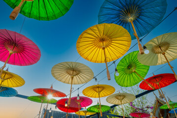 Mulberry paper umbrella that are hung over the road to decorate on the background of the bright sky...