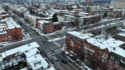 Historic district of American city covered in snow during winter. Aerial.